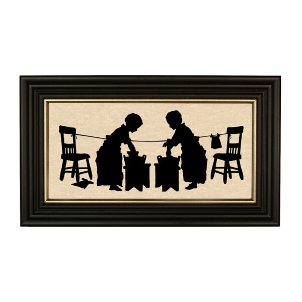 Early American Early American Children Washing Clothes Framed Paper Cut Silhouette in Black Wood Frame with Gold Trim. A 5″ x 10″ framed to 7″ x 12″.